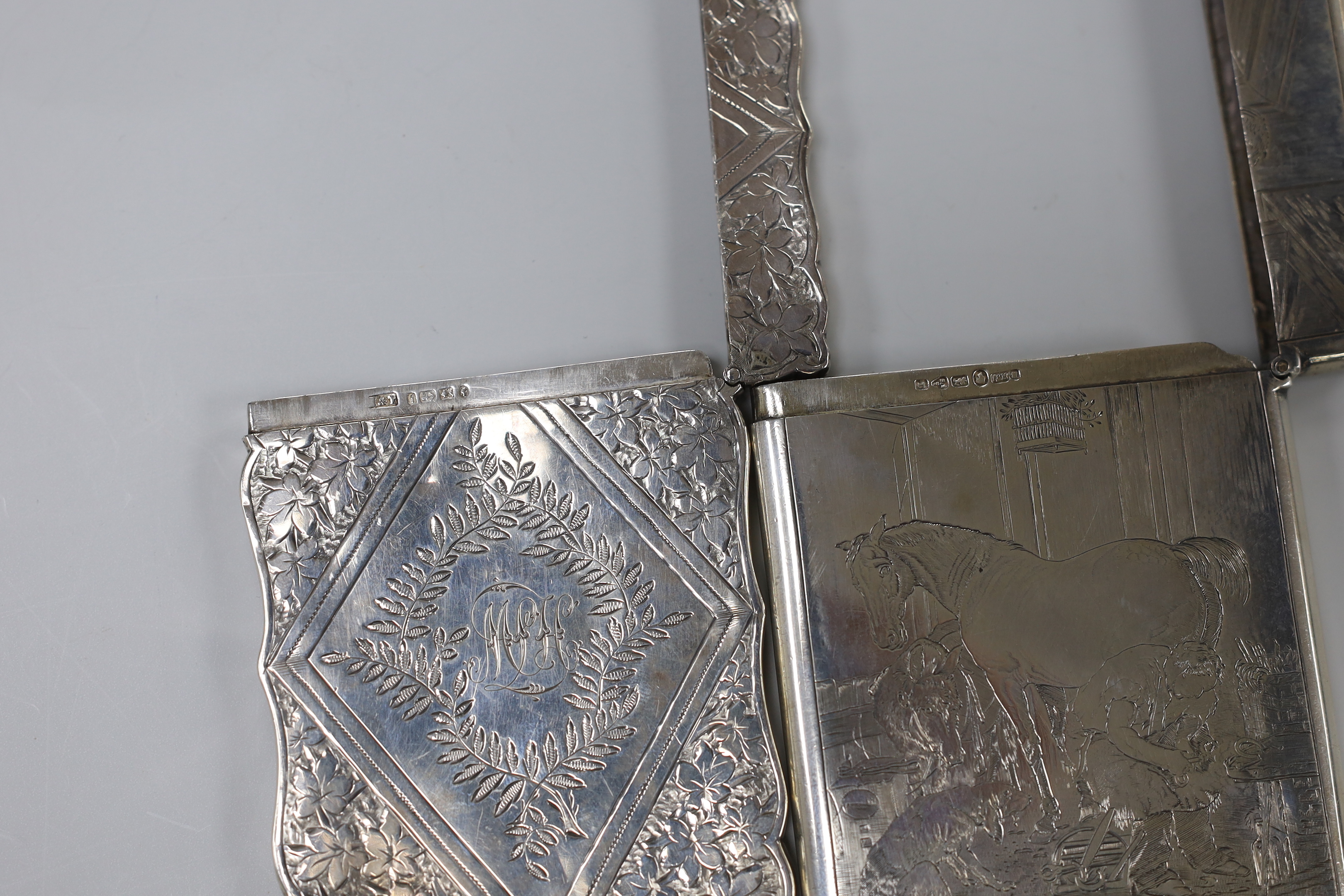 Two Victorian silver card cases, one engraved with farrier in a barn, B.H. Joseph & Co, Chester, 1880, 93mm, the other with foliate decoration, by Levi & Salaman.